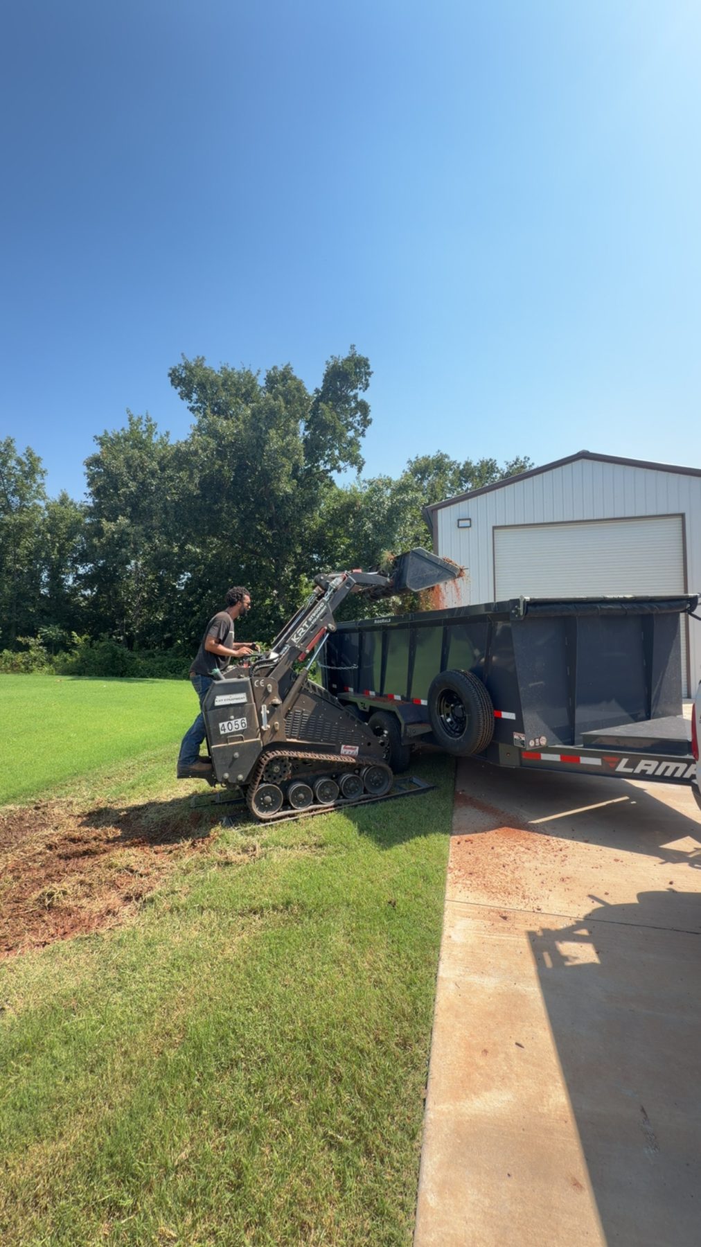 NexGen mini skid steer loading dirt into dump trailer