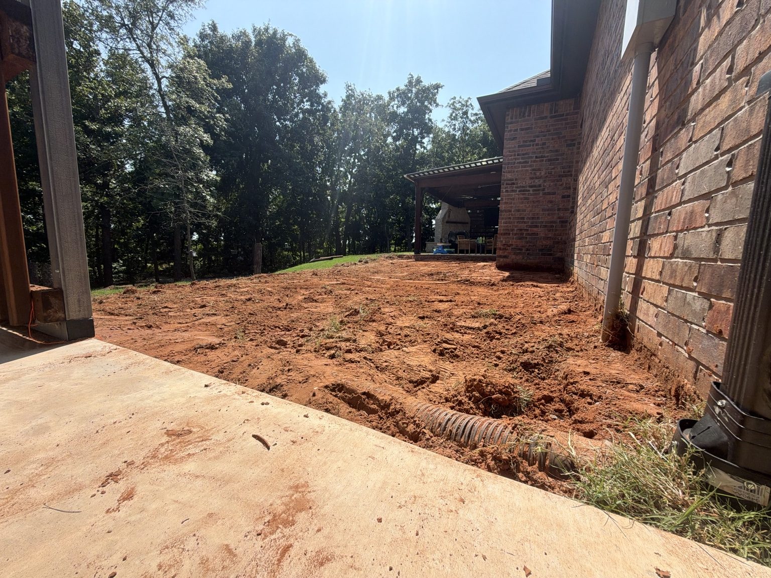 Mini skid steer grading residential yard
