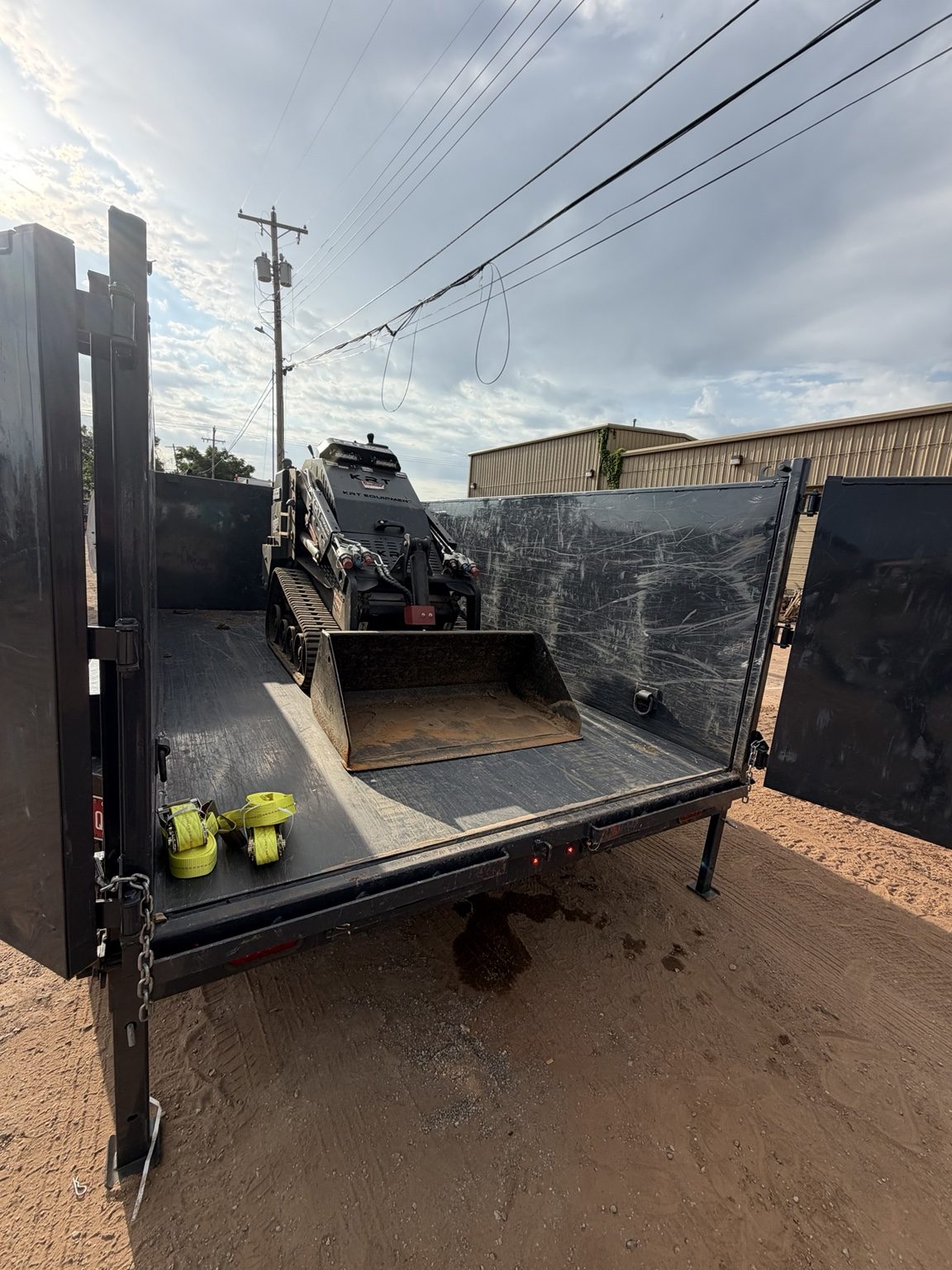 Mini skid steer removing turf and leveling yard